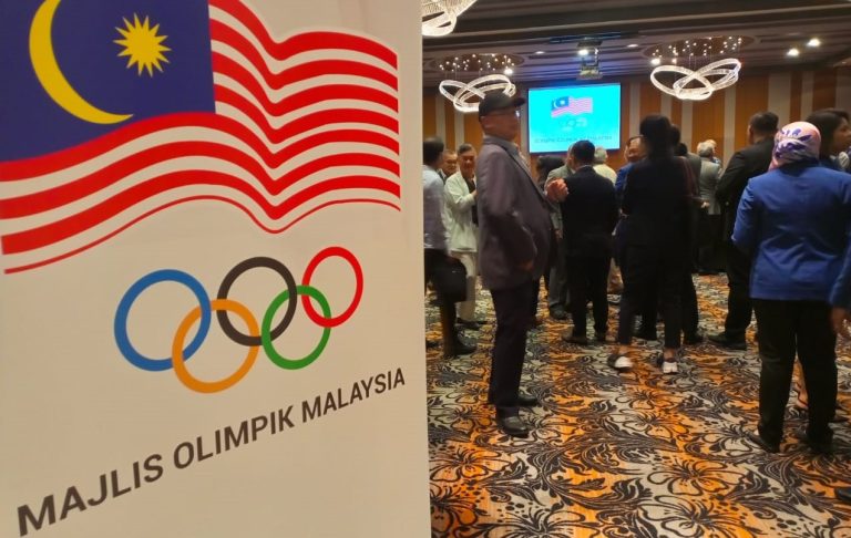 An Olympic Council of Malaysia banner greets guests at a function.