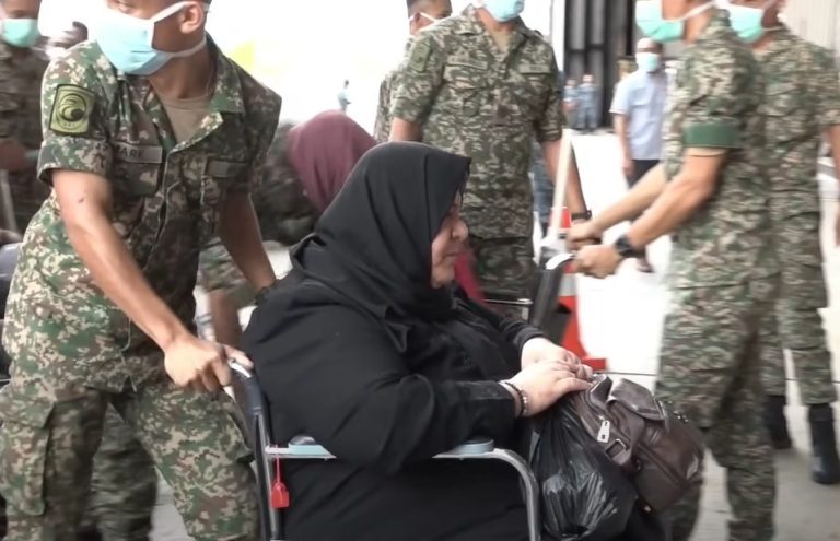 An air force officer pushing a Palestinian patient who arrived in Malaysia on Aug 17, 2024.