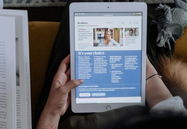Woman reading news on her tablet.
