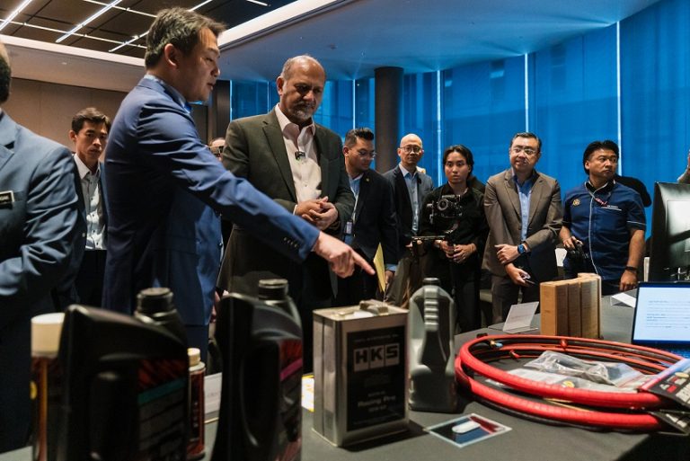 Digital Minister Gobind Singh Deo looking at several products following the signing ceremony of a collaboration agreement between Cybersecurity Malaysia and MyORI Services Sdn Bhd in Cyberjaya on Nov 26, 2024.