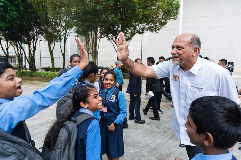 Digital Minister Gobind Singh Deo gives a student a high five at Multimedia University in Cyberjaya, Selangor on Jan 4, 2025.