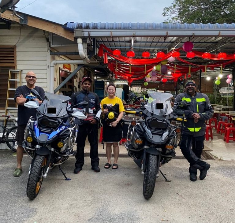 Two motorcyclists explore a Malaysian town.