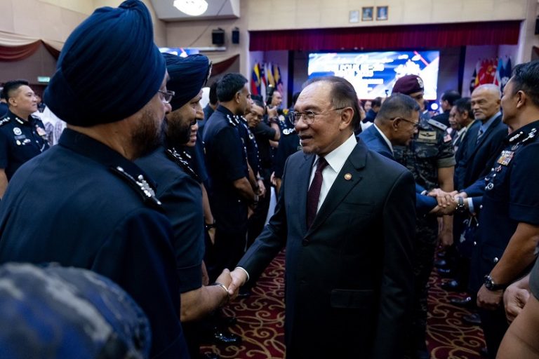 Prime Minister Datuk Seri Anwar Ibrahim greets police officers after officiating the 218th Police Day celebration at Pulapol, Kuala Lumpur today (March 25, 2025).
