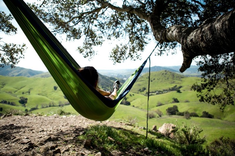 A woman relaxing on a hammock.