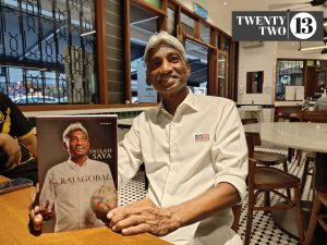 Datuk K. Rajagobal posing with his book 'Inilah Kita' at an eatery in Publika, Kuala Lumpur on May 29, 2025.