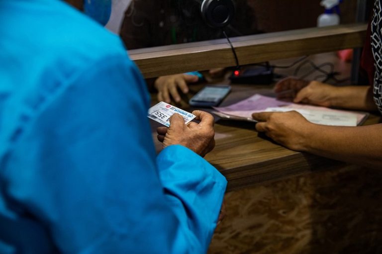 A man holding a refugee card.