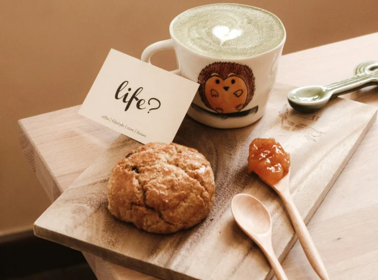 A shot of coffee, muffin and a card that reads 'Life?'