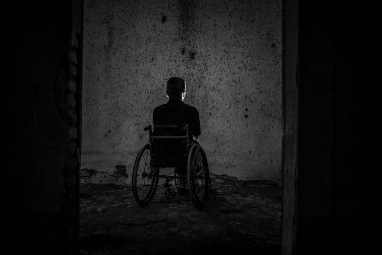 An image of a disabled person looking at a wall.