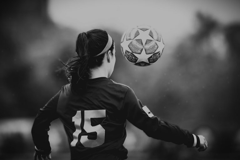 A woman playing football.