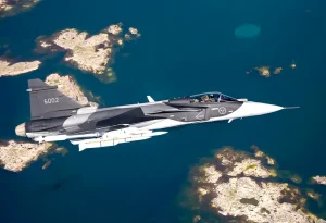 A Saab JAS-39 Gripen E fighter jet in the air.