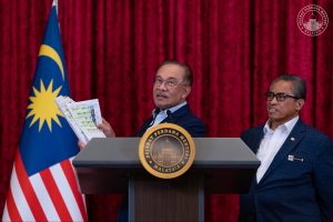 Datuk Seri Anwar Ibrahim showing the list of ministers following a Cabinet reshuffle on Dec 16, 2025.