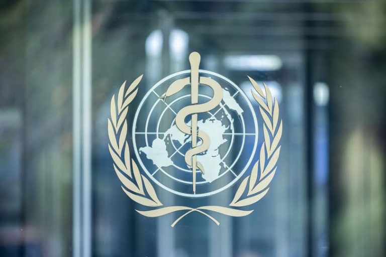 WHO logo on a glass door at its headquarters in Geneva.