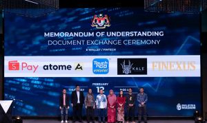 MyDigital ID chief executive officer Nik Hisham Nik Ibrahim (third left), and National Cyber Security Agency chief executive Dr Megat Zuhairy Megat Tajuddin (fourth left) with representatives from the fintech and e-wallet industry.