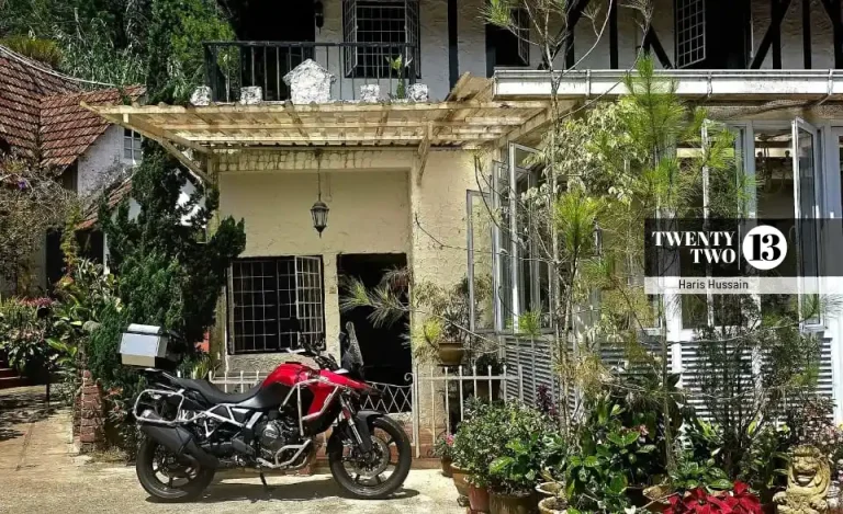 Haris Hussain's motorcycle parked in front of a building in Tanah Rata, Pahang.
