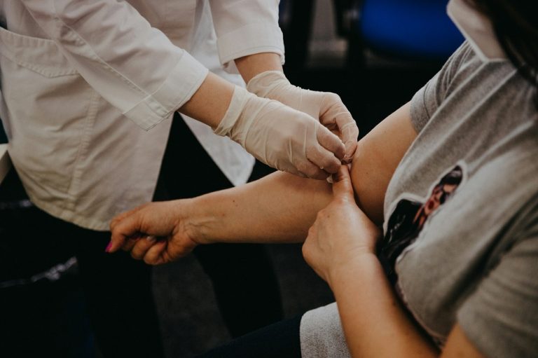 A doctor draws blood from a patient.