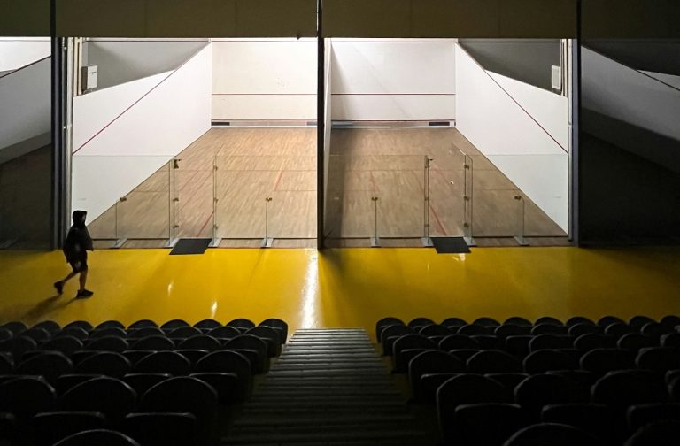 View of two squash courts from the stands.