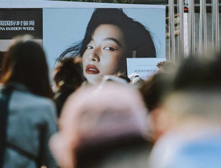 A poster of a model amongst the crowd at Asian Fashion Week 2026.