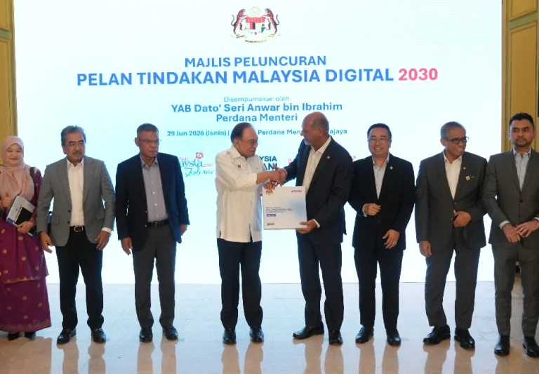 Prime Minister Datuk Seri Anwar Ibrahim shakes Digital Minister Gobind Singh Deo's hands at the launch of the Pelan Tindakan Malaysia Digital 2030 in Putrajaya on June 29, 2026.