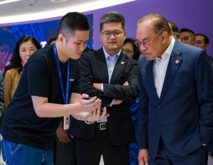 Anwar Ibrahim watching a presentation by an Ant International representative on July 1, 2026.