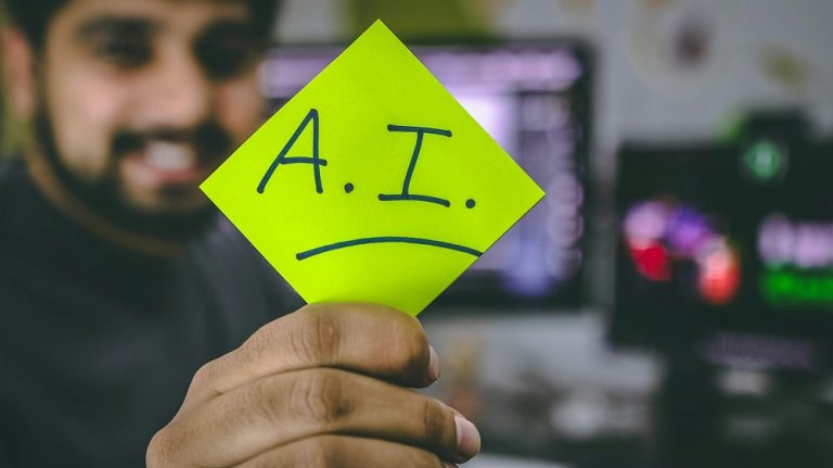 A man holding an AI sticker.