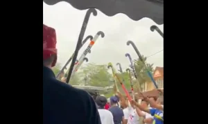 Former hockey players held hockey sticks in the air as Sarjit Singh was taken into the hearse on Aug 25, 2026.